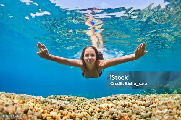 Young Woman Dive Underwater Over Coral Reef In Sea Stock Photo - Download Image Now - Beach, Jumping, Nusa Dua