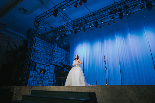 Young Chinese Female opera singer performing solo on stage