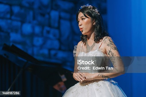 istock Young Chinese Female opera singer performing solo on stage 1468187286