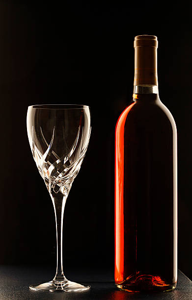Bottle of red wine with empty glass stock photo