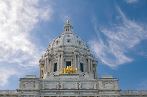 Photo of the Minnesota State Capitol building showing the dome, the quadriga and lower story rooftop