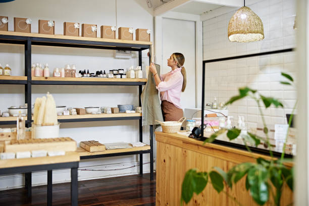 istock Sales clerk taking apron off hook in specialty shop 1468188892