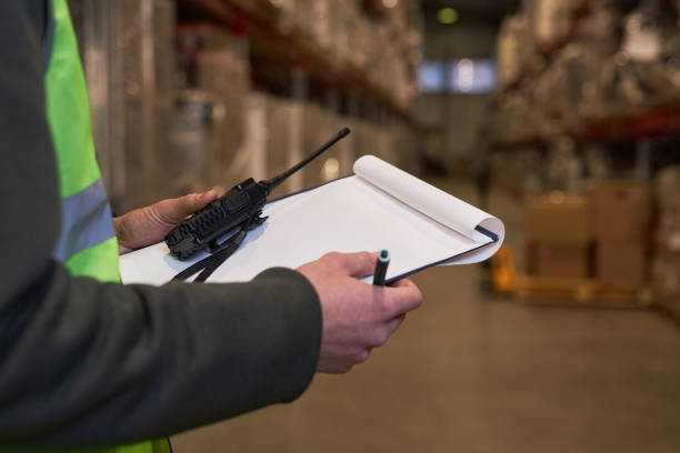 istock Close up of unrecognizable worker holding clipboard in warehouse 1468190990