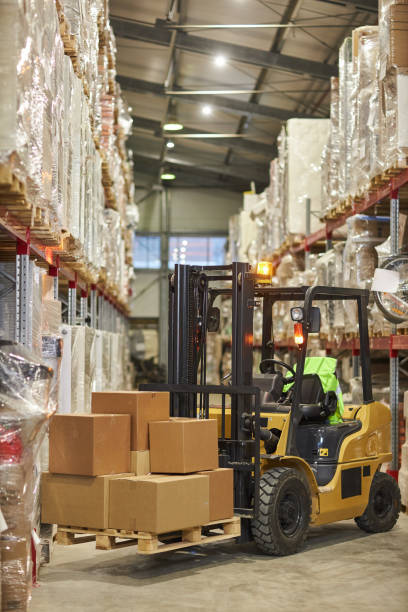istock Vertical background image of forklift truck carrying boxes in warehouse 1468191004