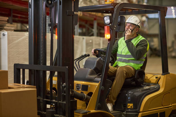 istock Bearded male worker driving forklift truck in warehouse 1468191185