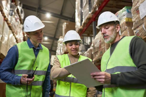 istock Group of three workers in warehouse holding clipboard 1468191283