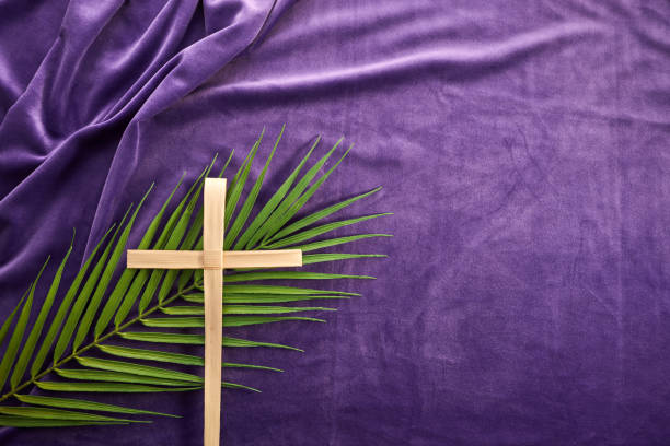Lent season, Holy week and Good friday concept. Palm leave and cross on purple background Lent season, Holy week and Good friday concept. Palm leave and cross on purple background. lent stock pictures, royalty-free photos & images