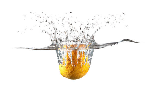 Orange Fruit Falling in Water Splash stock photo