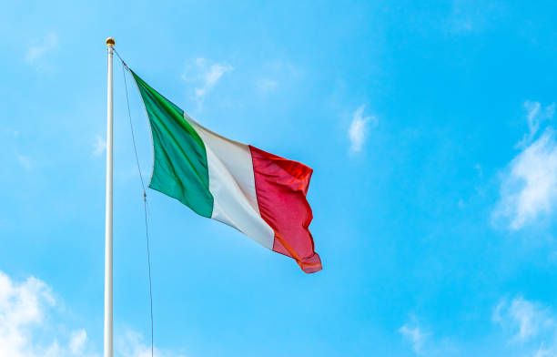 istock Italian flag waving in the wind against blue sky. 1468198785