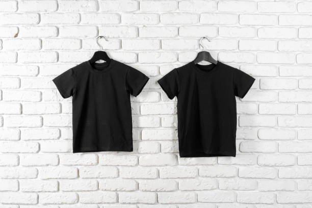 istock Black t-shirt hanging on a hanger against brick wall 1468205347