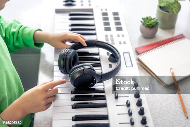 Closeup Black Headphones In The Hands Of A Child Music Concept Stock Photo - Download Image Now