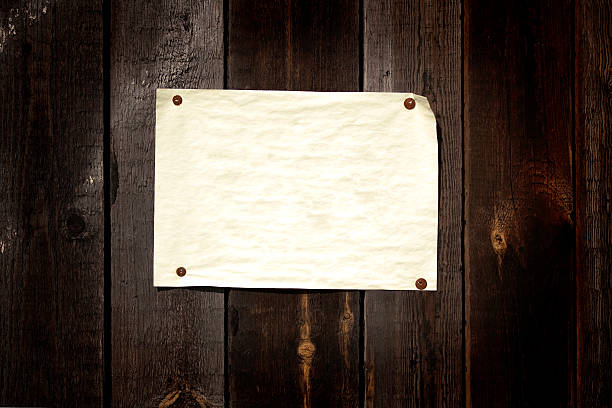 Old paper tacked to a wood wall stock photo