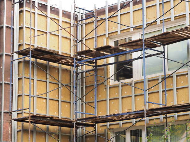 thermal insulation of the building wall with mineral thermal insulation. metal scaffolding stock photo