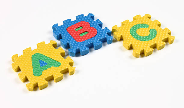 Puzzle pieces of alphabets stock photo