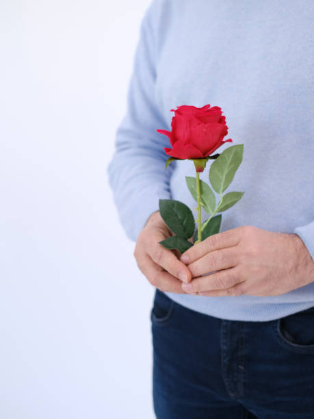 istock Part body man holding a red rose on his hands. Copy space. Selective focus 1468216794