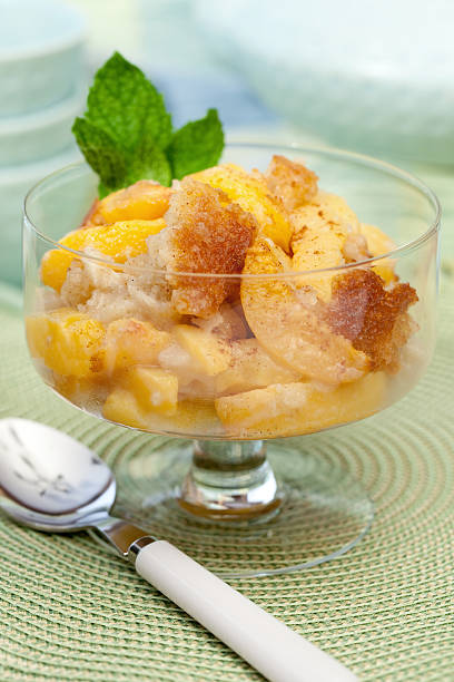 Baked peach cobbler in glass dish stock photo