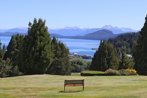 empty square bench, on top of a hill, overlooking the lake nahuel huapi