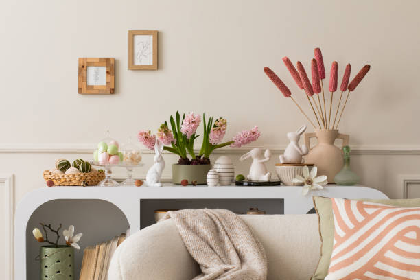 istock Interior design of easter living room interior with mock up poster frame, stylish white sideboard, hyacinth, easter bunny, vase with dried flowers and personal accessories. Home decor. Template. 1468219002