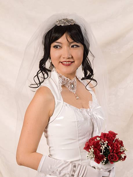 PVC Asian Bride - looking over shoulder to her right stock photo
