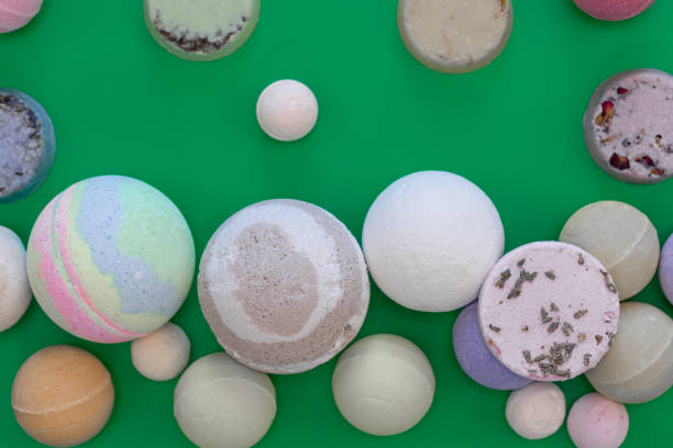 istock Multicolored bath bombs on a green background, top view. 1468222597