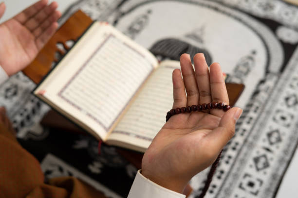 istock person praying in mosque with Quran book background 1468224895
