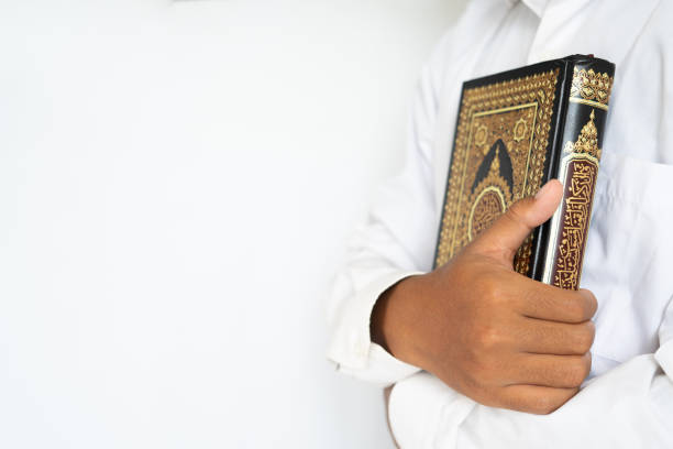 istock Man hug the holy Quran for copy space 1468224952