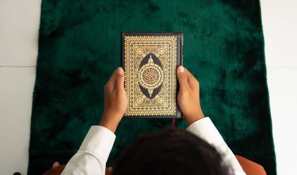 istock Man holding Quran book in top angle 1468225009
