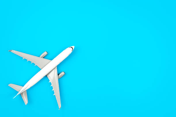istock White plane, airplane on a blue background, flat lay, copy space. 1468225199