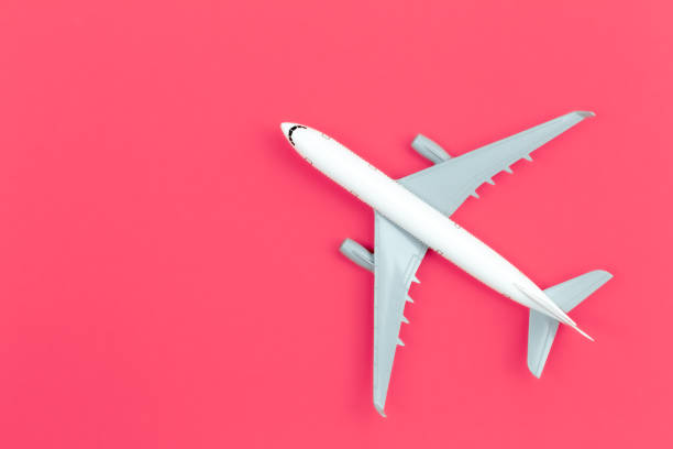 istock Airplane on a pink background, flat lay, travel concept. 1468225206
