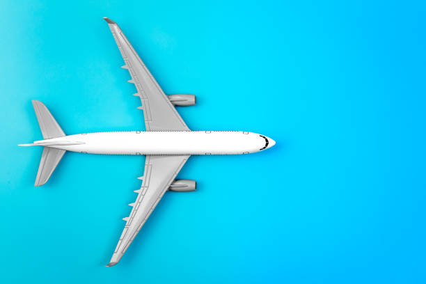 istock White plane, airplane on a blue background, flat lay, copy space. 1468225208