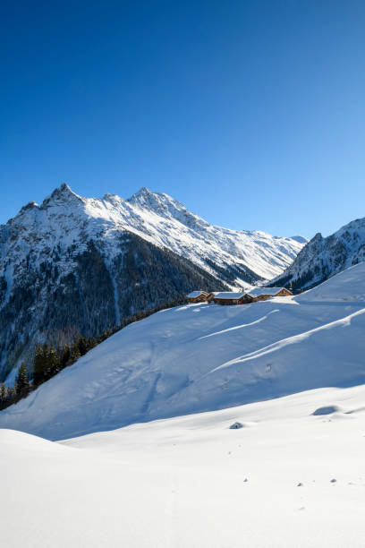 istock Winter landscape with snowcapped old huts in the mountains 1468225270