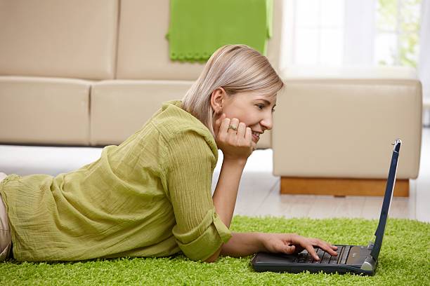 istock Woman laying on floor on the computer 146822570