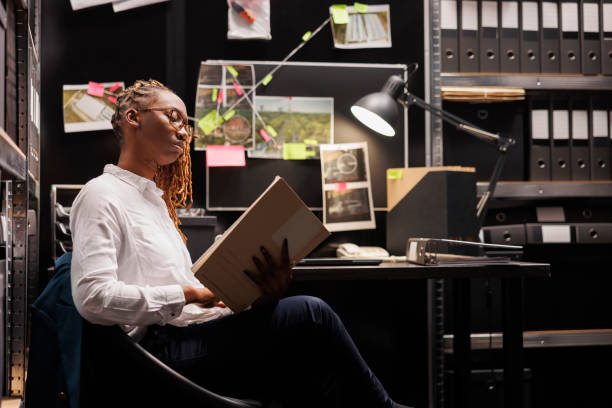 istock Woman detective analyzing evidence and reading crime case file 1468225716