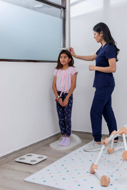 istock Paediatrician checking a child's height in her medical office 1468226532