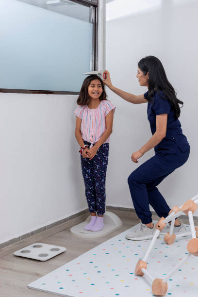istock Paediatrician checking a child's height in her medical office 1468227094