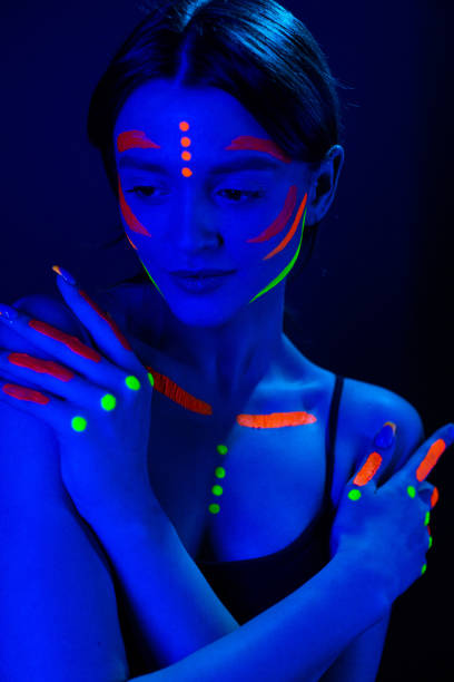 istock Girl with ultraviolet make-up in neon light. 1468228100