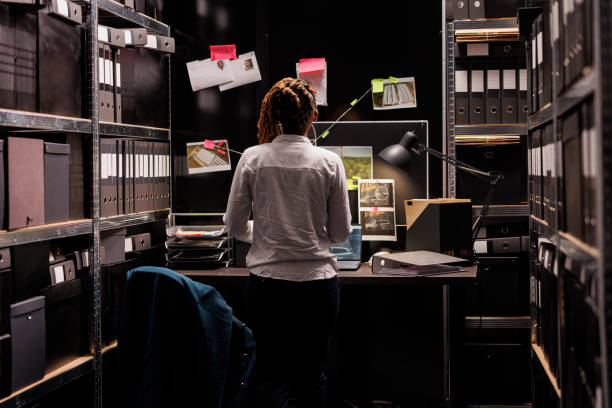 istock Woman investigator looking at detective board, analyzing evidence 1468228270