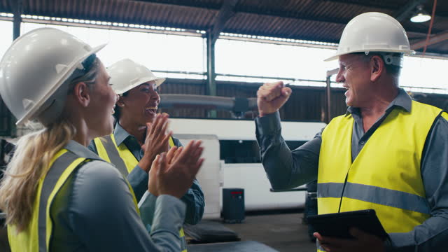 Tablet, engineer high five and team celebrate factory manufacturing plant, warehouse production or industrial inspection. Engineering teamwork, celebration applause and people with industry success