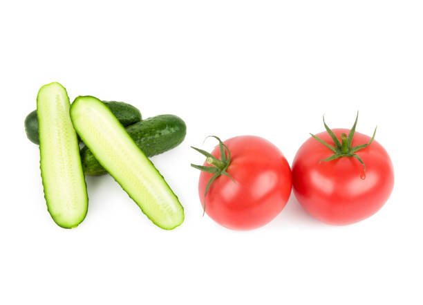 istock Ripe tomatoes and cucumbers isolated on white . 1468229957