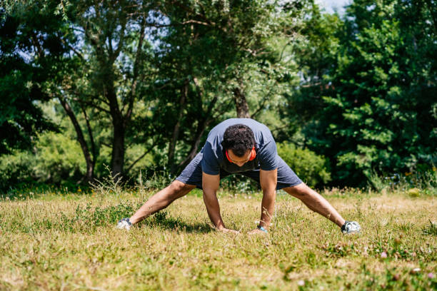 istock Young Man Stretching Before Jogging In The Park 1468230648