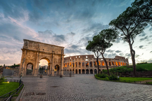 Amazing panoramic view of Arch of Constantine (Arco di Constantino) and Colosseum the blue hour before sunrise, Rome, Italy.