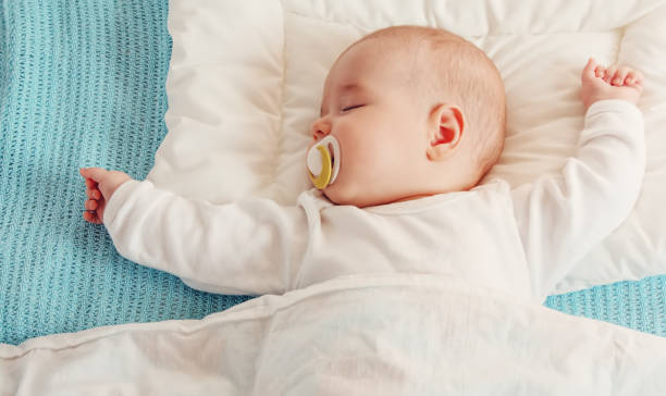 istock Cute three month old baby sleeping in comfortable bed. 1468233075