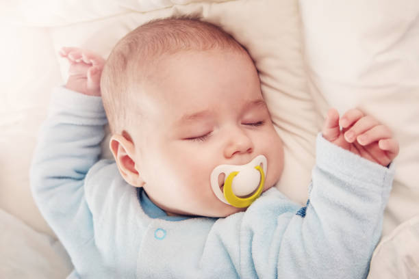 istock Cute three month old baby sleeping in comfortable bed. 1468233121
