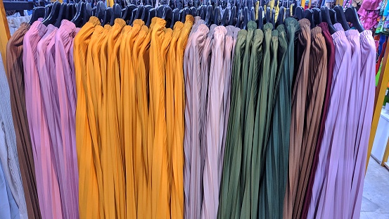 rainbow colors in a clothing store, which can be seen from the hanging women's clothes