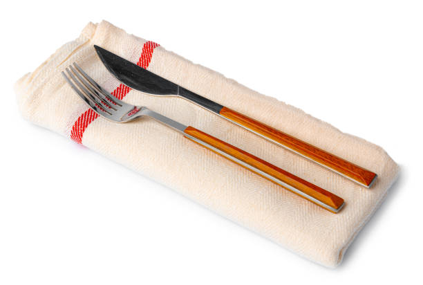 Set of fork and knife on towel. Isolated on white background. Top view.