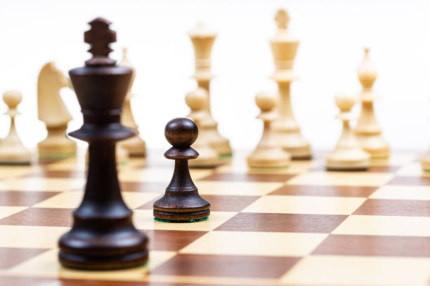 istock moving black pawn and queen against white chess 1468234087