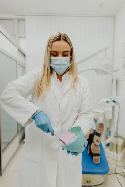 istock Female dentist preparing material for dental impressions 1468234871