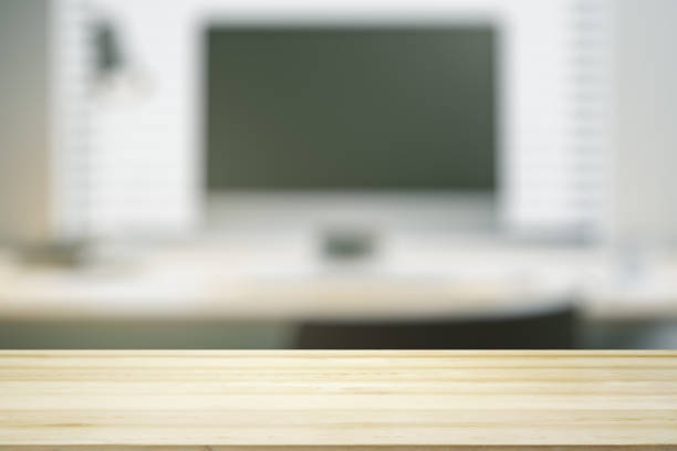 istock Blank wooden office desk with light workplace with laptop on background, mock up 1468235236