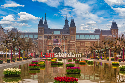 Amsterdam, Netherlands - April 15, 2018: Amsterdam Netherlands, city skyline at Rijksmuseum (Dutch National Museum) and I Amsterdam Sign with tulib flower