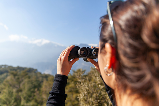 Portrait of women looking through binoculars